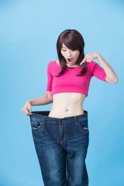 istock woman show weight loss 933368220