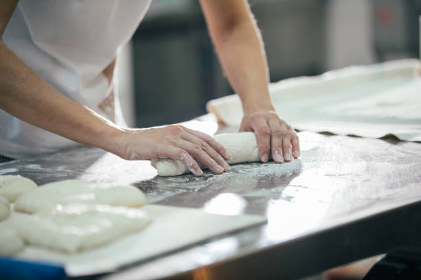 istock Baker preparing bread. Close up of hands kneading dough. Bakery concept. 933373582