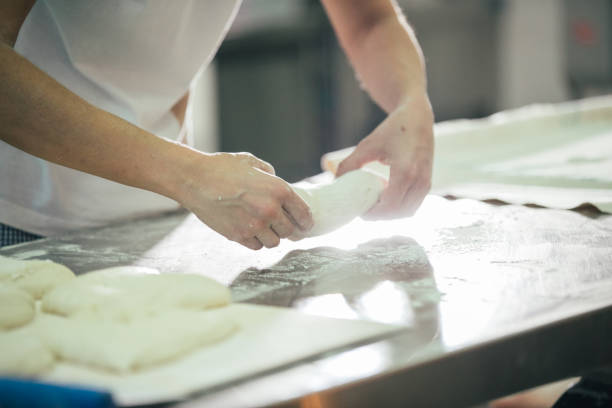 istock Baker preparing bread. Close up of hands kneading dough. Bakery concept. 933373584