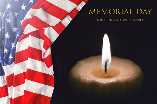Text MEMORIAL DAY with the American flag and a burning candle