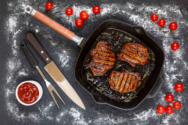 steaks grilled, grilled, steak, beef, balsamic, rosemary, stone table, cherry tomatoes, ketchup, top view, - picanha beef meat rare imagens e fotografias de stock