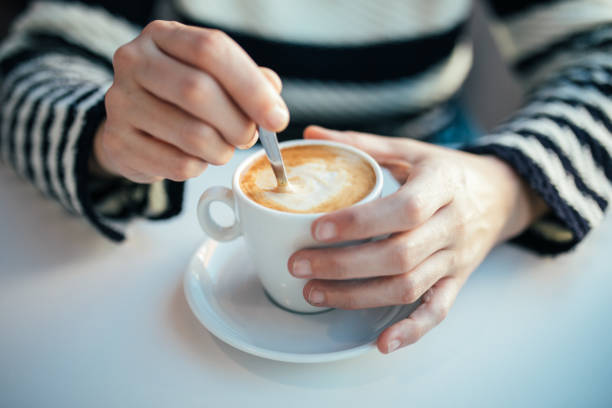 istock Female hands holding cups of coffee 933376266