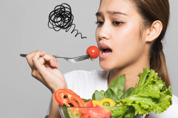 istock Young woman who hates vegetables. 933380400
