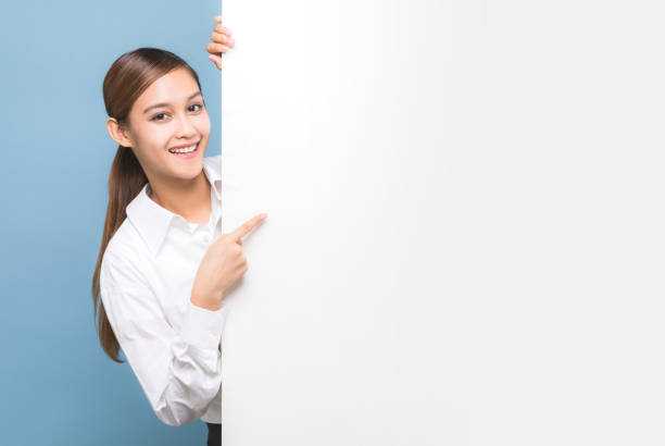 istock Young woman pointing message board. 933380808