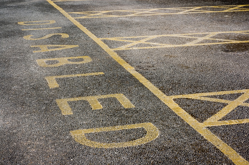 Disabled parking spaces marked out on salted tarmac in Scotland, UK. 
