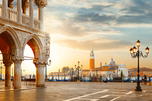 Venice postcard. World famous Venice landmarks. St. Mark's San Marco square with San Giorgio Maggiore church during amazing sunrise. Tourism and travel concept in Italy.