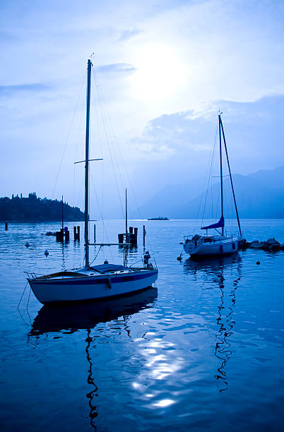 ヨット停泊中の - lake garda sunset blue nautical vessel ストックフォトと画像