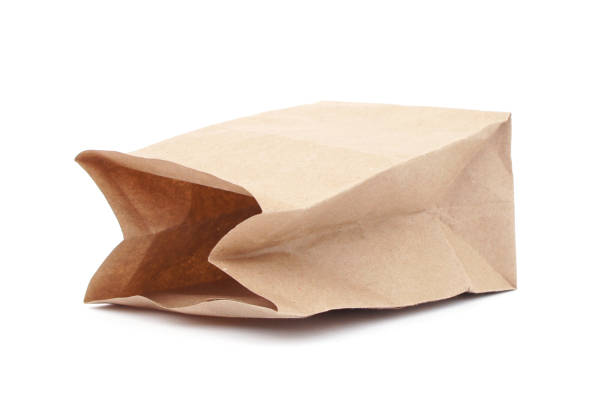 istock Empty brown paper package isolated on white background. Side view. close-up. 933390344