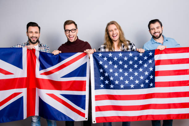 istock Coalition collaboration people fan teaching working plus union concept. Handsome cheerful excited guys, checkered denim jeans clothes, holding jack union, us flags isolated on gray background 933401580