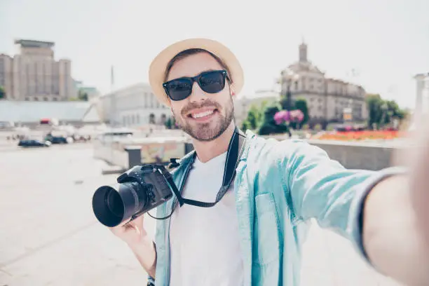 Photo of Video call internet online connection modern technology concept. Close up portrait of excited cheerful joyful handsome wearing casual jeans denim shirt white tshirt holding digicam taking picture