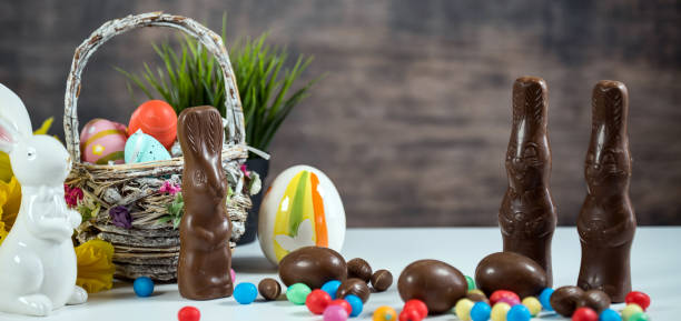 istock Delicious chocolate easter eggs ,bunny and sweets on dark wood background 933408160
