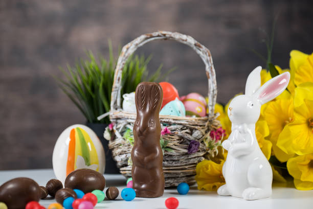 istock Delicious chocolate easter eggs ,bunny and sweets on dark wood background 933408220