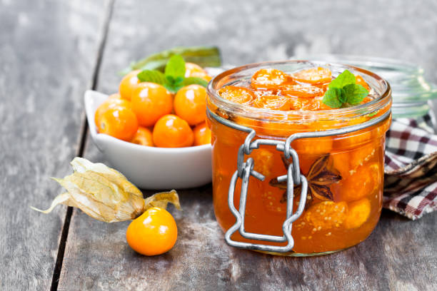 istock Homemade  physalis jam in jar on wooden table 933408312