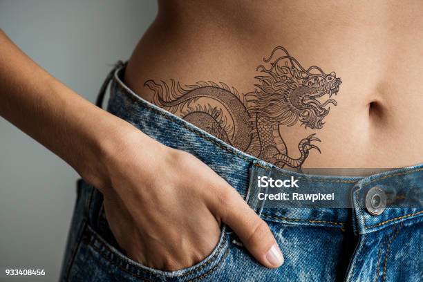Closeup Of Lower Hip Tattoo Of A Woman Stock Photo - Download Image Now -  Tattoo, Dragon, One Woman Only - iStock