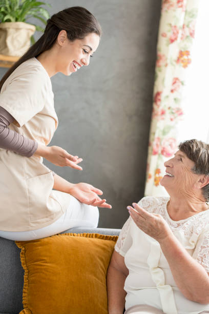 istock Senior woman conversating with caregiver 933417418