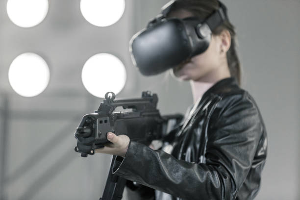 istock Young Woman Shooting Handgun in Virtual Reality 933425398