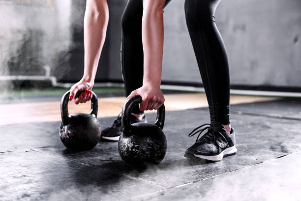 istock Girl is exercising with a kettle-bell 933431244