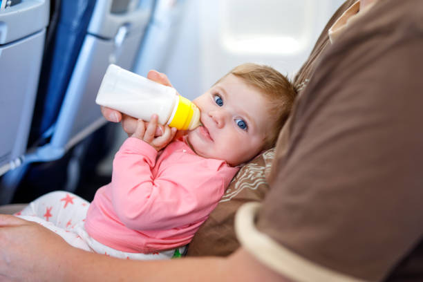 istock Father holding his baby daughter during flight on airplane going on vacations 933434618
