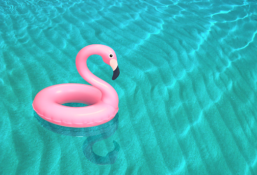 Inflatable pink flamingo floating on the sea surface. 3D rendering