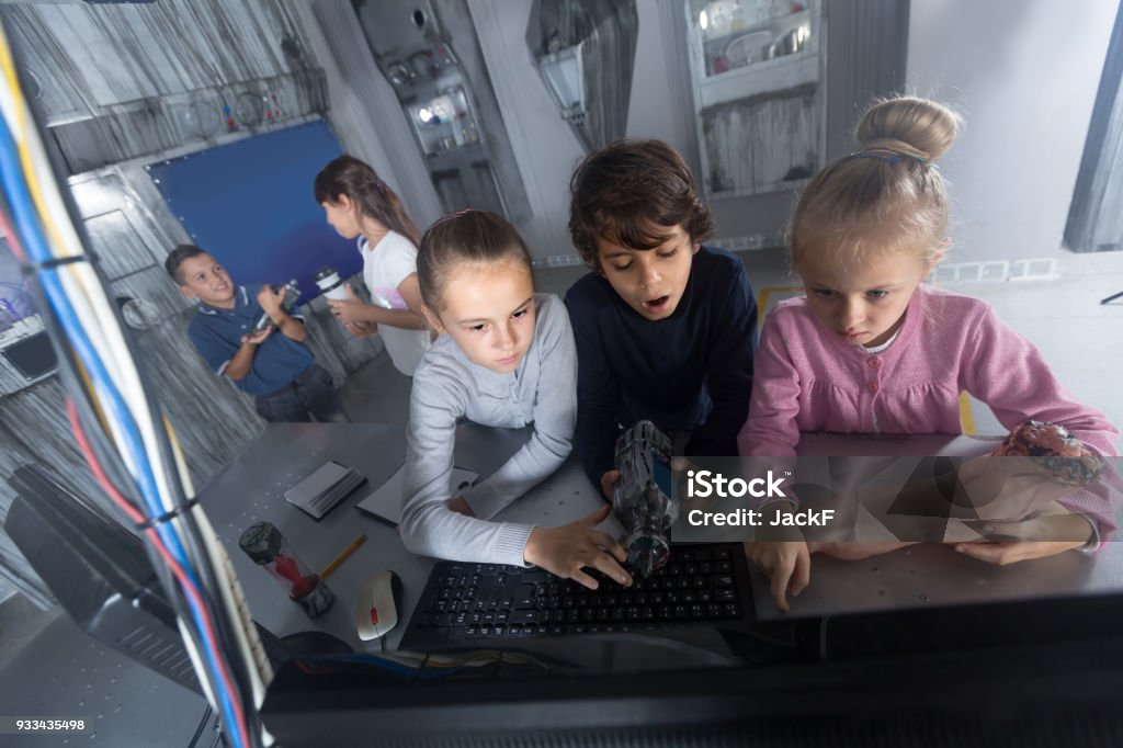 children play in the quest room of a inscrutable bunker Enthusiastic russian children play in the quest room of a inscrutable bunker 6-7 Years Stock Photo