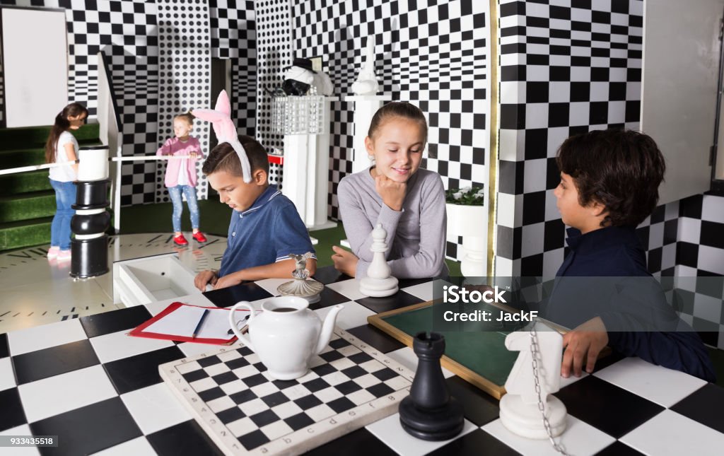 children play in escape room in chess style Captured children play in escape room in chess style 6-7 Years Stock Photo