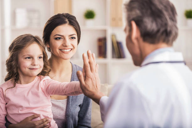 istock Mom with kid at the doctor. 933439180