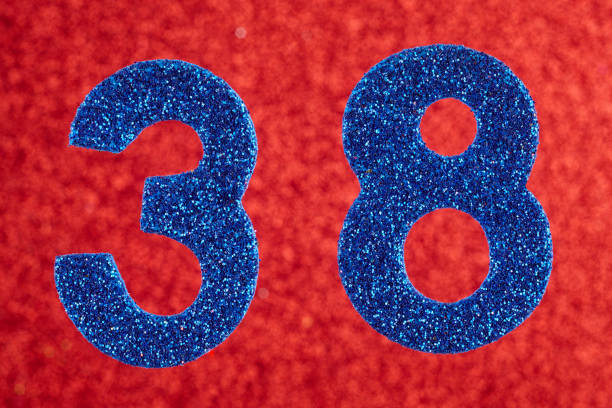 istock Number thirty-eight blue color over a red background. Anniversary 933439638