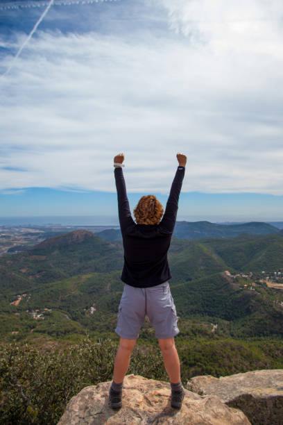 istock Woman on top of a mountain 933445752
