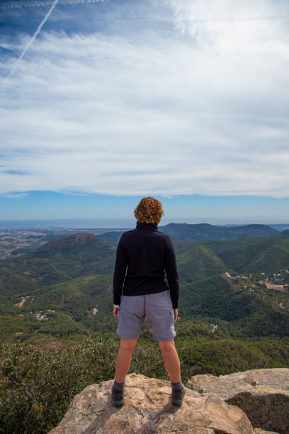 istock Woman on top of a mountain 933445762
