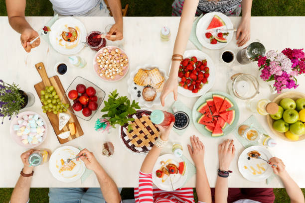 istock People eating fruits at table 933445812