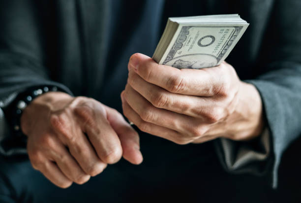 istock Closeup of hands holding cash 933445934