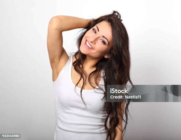 Beautiful Positive Fun Happy Woman In White Shirt With Toothy Smile Showing Her Epilation Armpit On White Background Stock Photo - Download Image Now