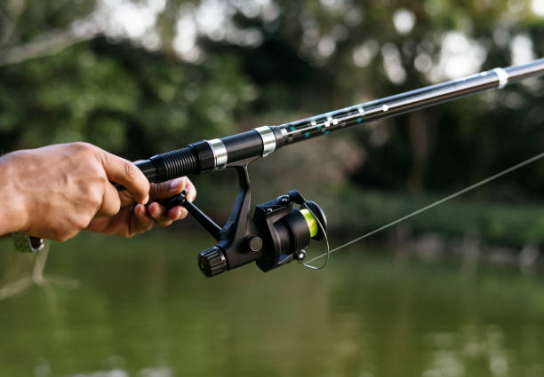 istock Man fishing in the jungle 933446302