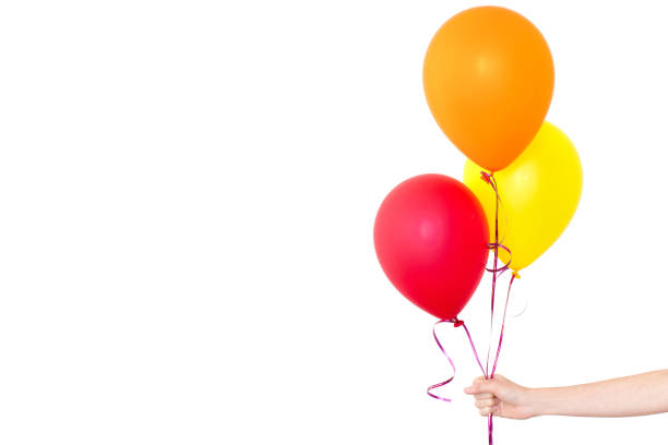 istock Womans hand holds balloons in a white background 933446838