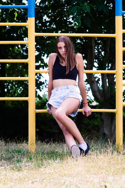 istock A beautiful young fashion model is dressed in jeans shorts 933453314