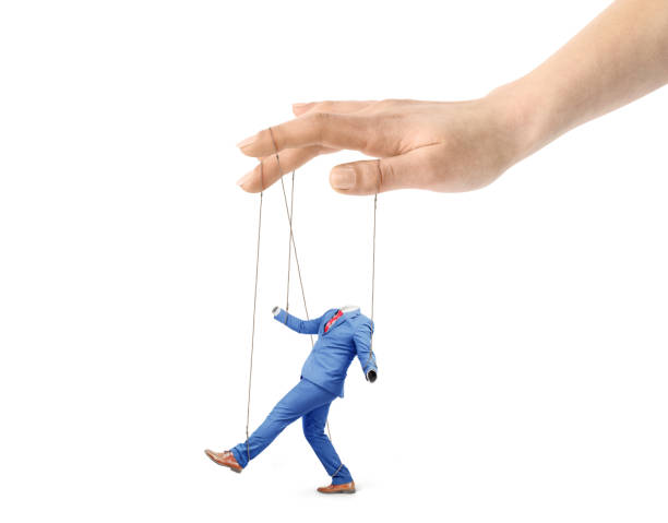 The concept of corporate slavery. A hand controls a worker on a white background. Submission of will. Puppet master. The concept of corporate slavery. A hand controls a worker on a white background. Submission of will. Puppet master. marionette stock pictures, royalty-free photos & images