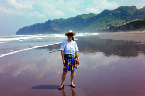 The nineties. At the Beach of Parangtritis. Yogyakarta, Indonesia. Yogyakarta, Indonesia, September 1991. A tourist enjoy the  Parangtritis beach which isn't too far from yogyakarta. central java province stock pictures, royalty-free photos & images