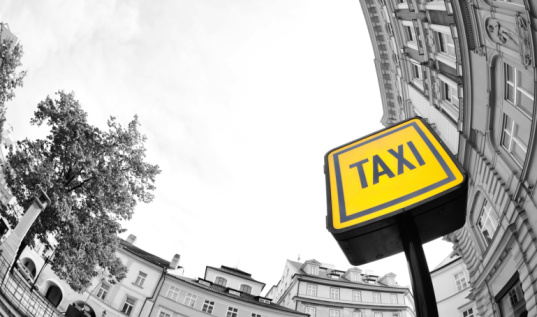 A fisheye lens view of a taxi rank sign.