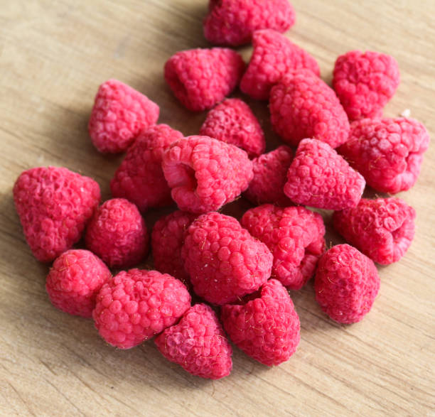 istock Frozen sweet eye raspberries on wooden background 933461474