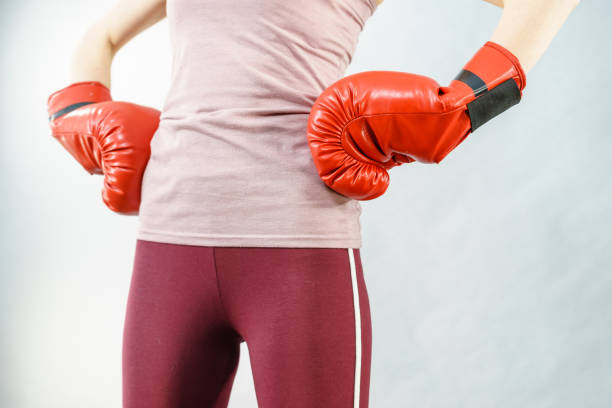 istock Woman wearing boxing gloves 933462380