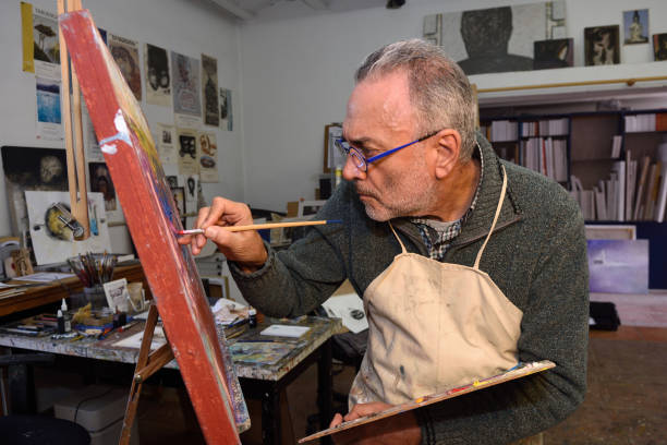 istock Painter artist painting a picture in the studio 933469738