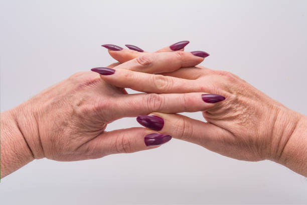 Mature Female Wrinkled Folded Hands With Purple Manicure Stock Photo -  Download Image Now - iStock