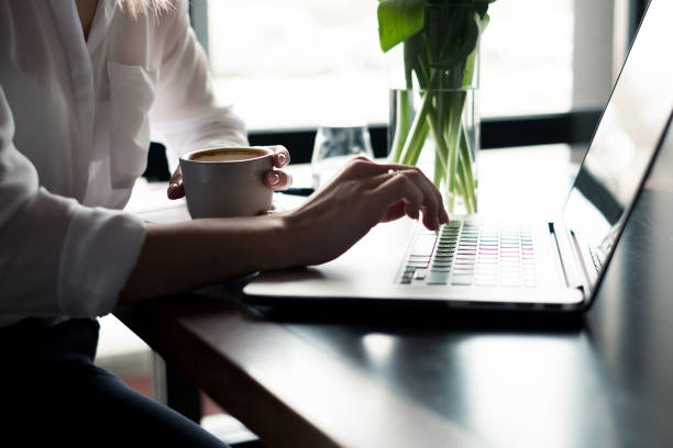 istock Businesswoman using laptop and drinking coffee 933470512