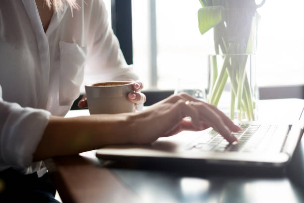 istock Businesswoman using laptop and drinking coffee 933470776