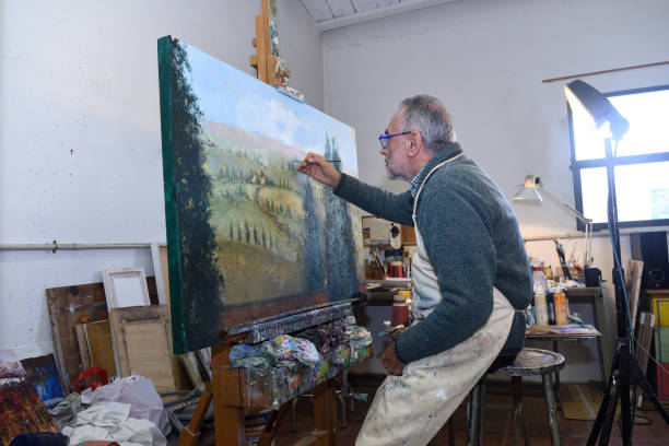 istock Painter artist painting a picture in the studio 933471422