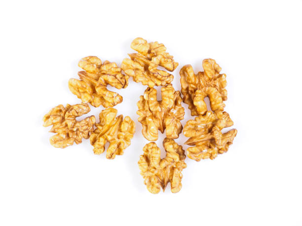 istock Top view with a handful of walnut, circassian nuts isolated on white background 933474976