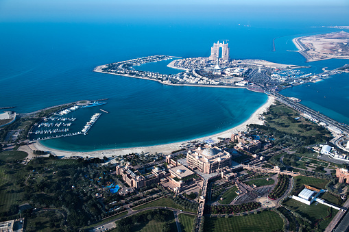 Helicopter point of view of Abu Dhabi skyscrapers and famous Emirates Palace Hotel.