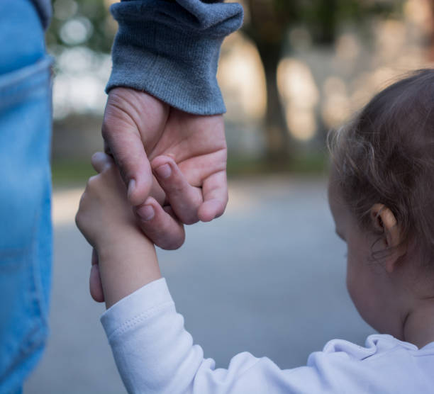 istock Father and Daughter Holding Hands 933475910
