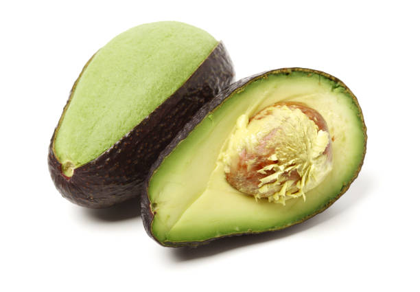 avocado su sfondo bianco - avocado cross section vegetable seed foto e immagini stock