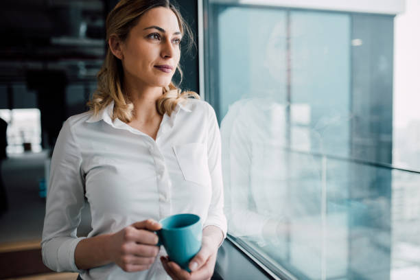 istock Thoughtful businesswoman looking through the window 933479454
